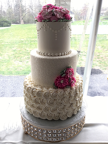 3 Tier buttercream wedding cake, decorated with rosettes, sugar crystals, chandeliers and buttercream flowers delivered to Allenberry in Boiling Springs PA