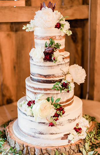 4 Tier semi naked wedding cake decorated with fresh flowers