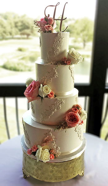 wedding cakes Lancaster PA. 4 Tier buttercream wedding cake, decorated with fondant lace and fresh flowers delivered to Lancaster PA