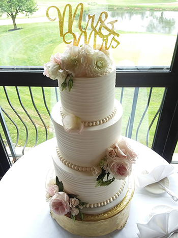 3 Tier textured buttercream wedding cake decorated with fresh flowers