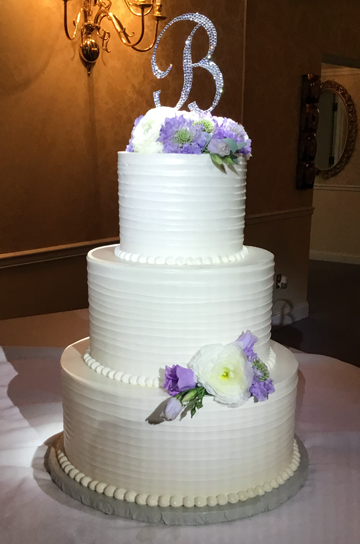 3 Tier simple and clean buttercream wedding cake with textured exterior decorated with fresh flowers delivered to Wisehaven Event Center in York PA