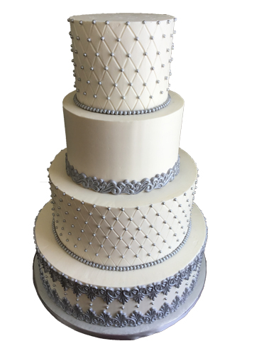 4 Tier buttercream wedding cake, decorated with quilt design, silver edible sugar pearls, and fondant lace borders delivered at The Stone Mill Inn York PA