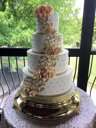 4 Tier buttercream wedding cake, decorated with edible gold pearls, gold buttercream scolls, gold pearl fondant borders and fondant handmade peach flowers delivered at Heritage Hills Golf Resort East York PA