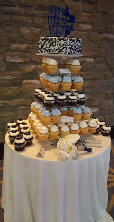 Small wedding cutting cake and cupcakes displayed on a square cupcake stand. Cupcakes Lancaster PA