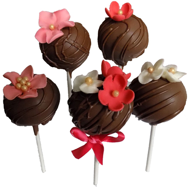 Yellow cake pops, dipped in milk chocolate and decorated with assorted sugar flowers. Cake pops York PA