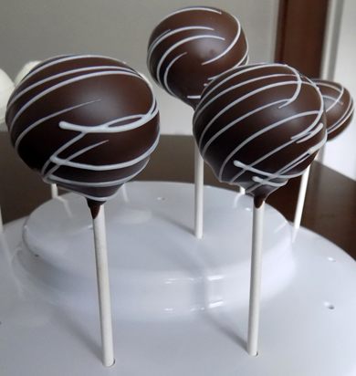 Yellow cake pops, dipped in dark chocolate and decorated with white chocolate stripes. Cake pops York PA
