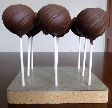 Chocolate vanilla cake pops, dipped in dark chocolate and decorated with dark chocolate stripes