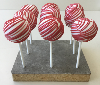 Cake pops dipped in white chocolate with red chocolate stripes. Cake pops Lancaster PA