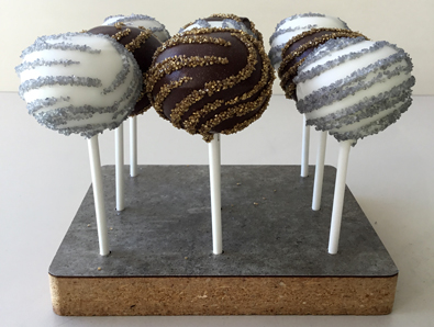 Cake pops dipped in milk and white chocolate with gold and silver sugar crystal stripes. Cake pops York PA