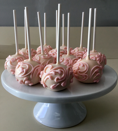 Cake pops dipped in blush chocolate with blush chocolate scrolls. Cake pops York PA
