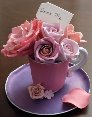 Custom handmade gumpaste tea cup and saucer with different shades of pink sugar roses