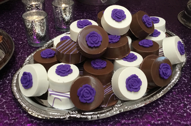 Chocolate Oreo cookies, dipped in dark chocolate and white chocolate with purple chocolate stripes and fondant flowers