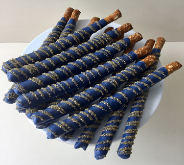 Navy blue chocolate pretzels with gold sanding sugar stripes