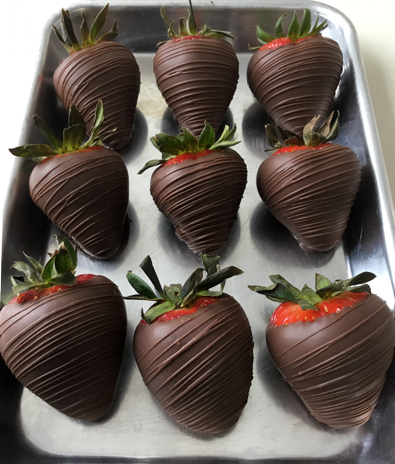 strawberries dipped in dark chocolate with chocolate stripes