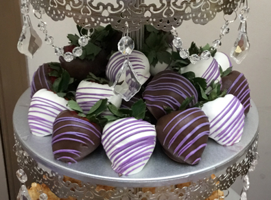 strawberries dipped in dark and white chocolate with light purple stripes