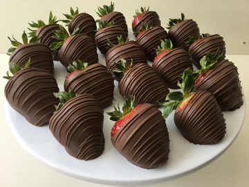 strawberries dipped in milk chocolate with milk chocolate stripes