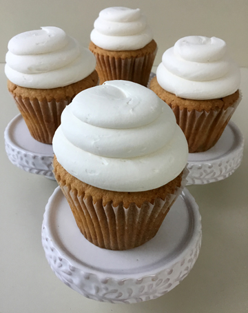 Vanilla cupcakes topped with swirls of vanilla buttercream using a plain tip