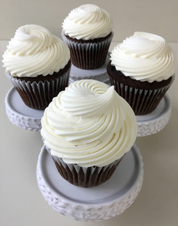 Chocolate cupcakes, topped with cream cheese icing using a French star tip