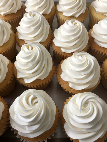 Vanilla cupcakes, topped with swirls of vanilla buttercream using a star tip