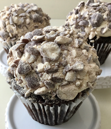 Chocolate cupcakes, topped with malt buttercream and covered in chopped malt ball candies