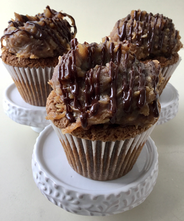 German chocolate cupcakes, filled with ganache, topped with coconut pecan filling and drizzled with ganache sauce