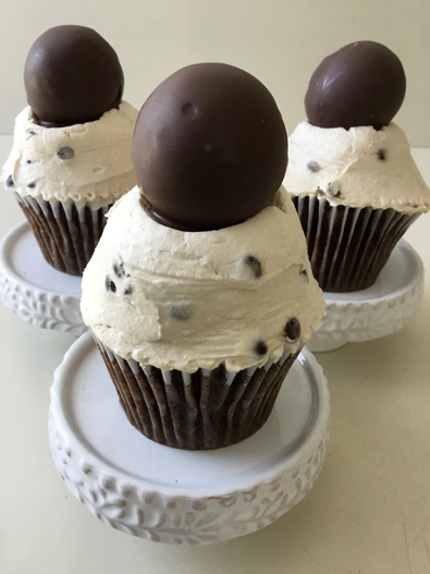 Chocolate cupcakes, filled with ganache, topped with chocolate chip cookie dough buttercream and chocolate dipped cookie dough balls