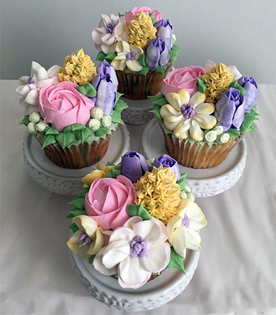 Confetti cupcakes, with strawberry filling topped with spring buttercream flowers using our sweet bakery buttercream icing