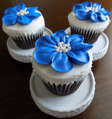 Chocolate cupcakes, filled with peanut buttercream, iced with vanilla buttercream and decorated with royal blue buttercream flowers and edible pearl centers delivered at the Peter Allen House in Dauphin PA