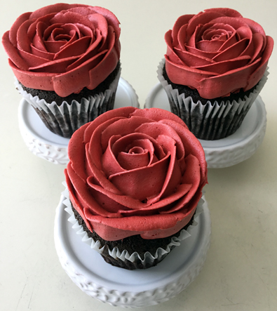 Cupcakes decorated with red buttercream roses