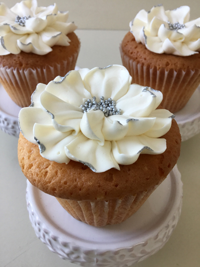 Wedding cupcakes decorated with large white buttercream flowers with silver centers and silver edges delivered at Wyndridge Farm Dallastown PA