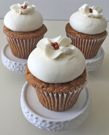 Pumpkin Spice cupcakes, topped with cream cheese icing and decorated with buttercream flowers with rose gold pearl centers