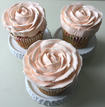 Confetti cupcakes decorated with light peach buttercream roses