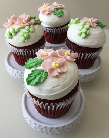 Wedding cupcakes, topped with vanilla buttercream and decorated with blush buttercream flowers and greenery delivered at Stone Mill Inn in PA