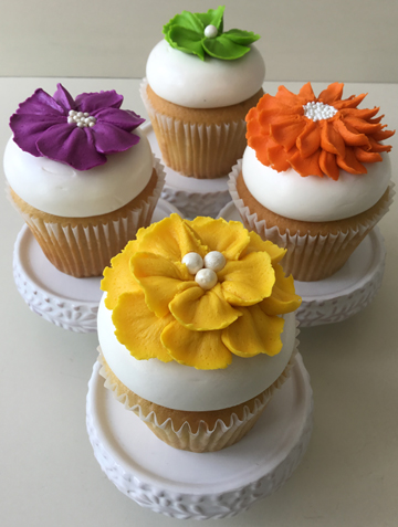 Wedding cupcakes decorated with an assortment of bright colored buttercream flowers delivered to Stone Mill Manor in Hallam PA
