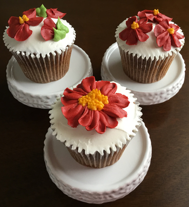 Spice cupcakes, iced with cream cheese icing and  decorated with deep red buttercream flowers delivered at Acorn Meadows in Thomasville PA