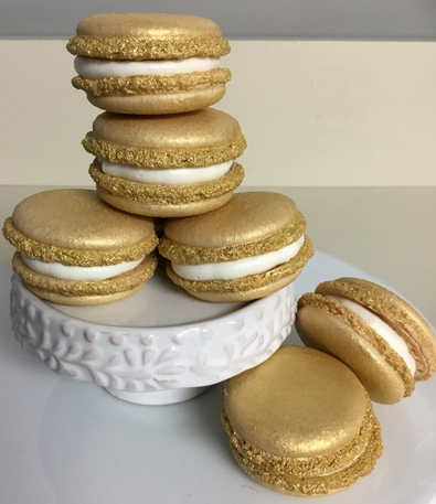 Gold French macarons filled with raspberry filling