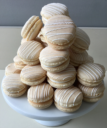 Gold French macarons filled with raspberry filling